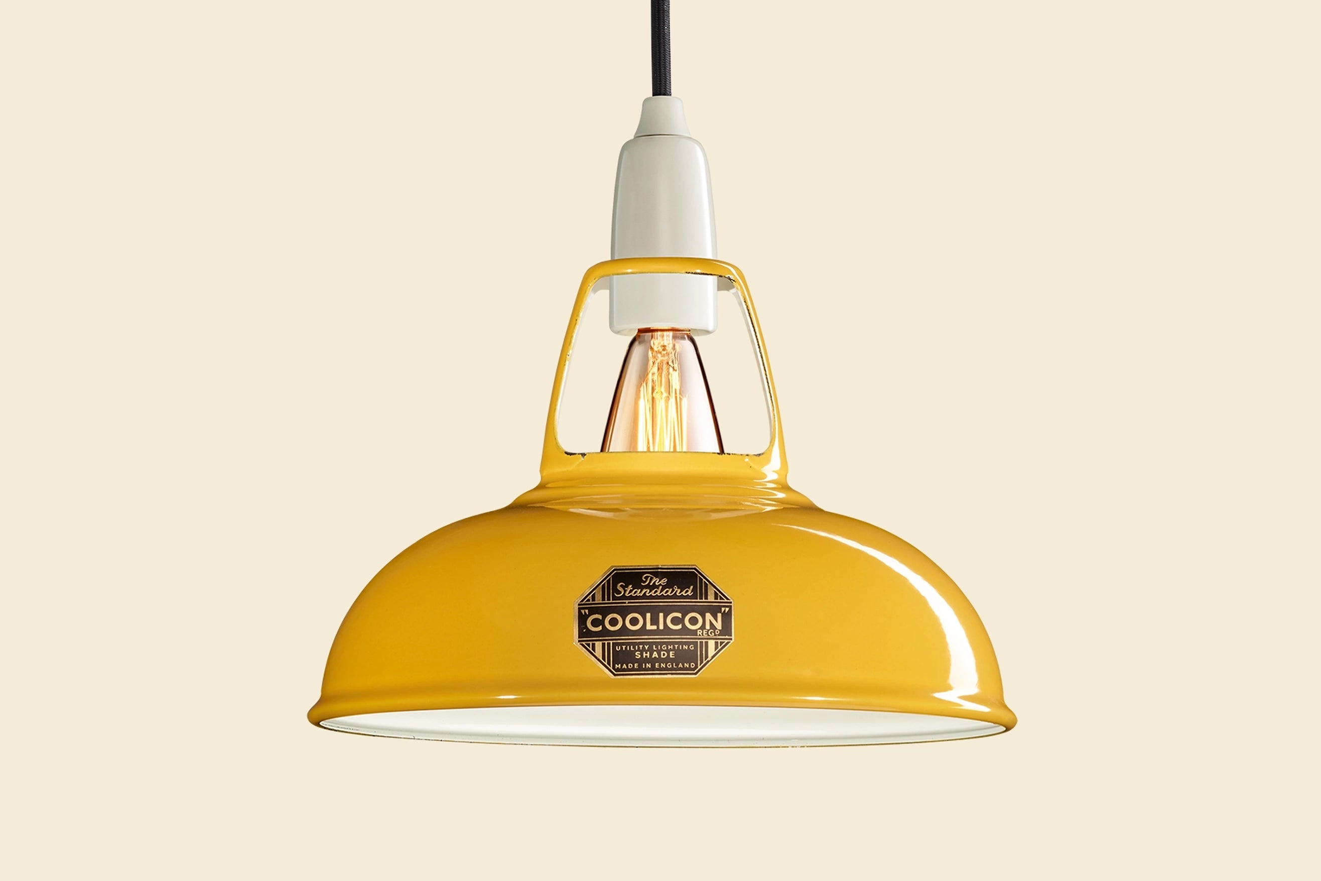 Deep Yellow Coolicon lampshade with a Porcelain pendant set over a yellow background