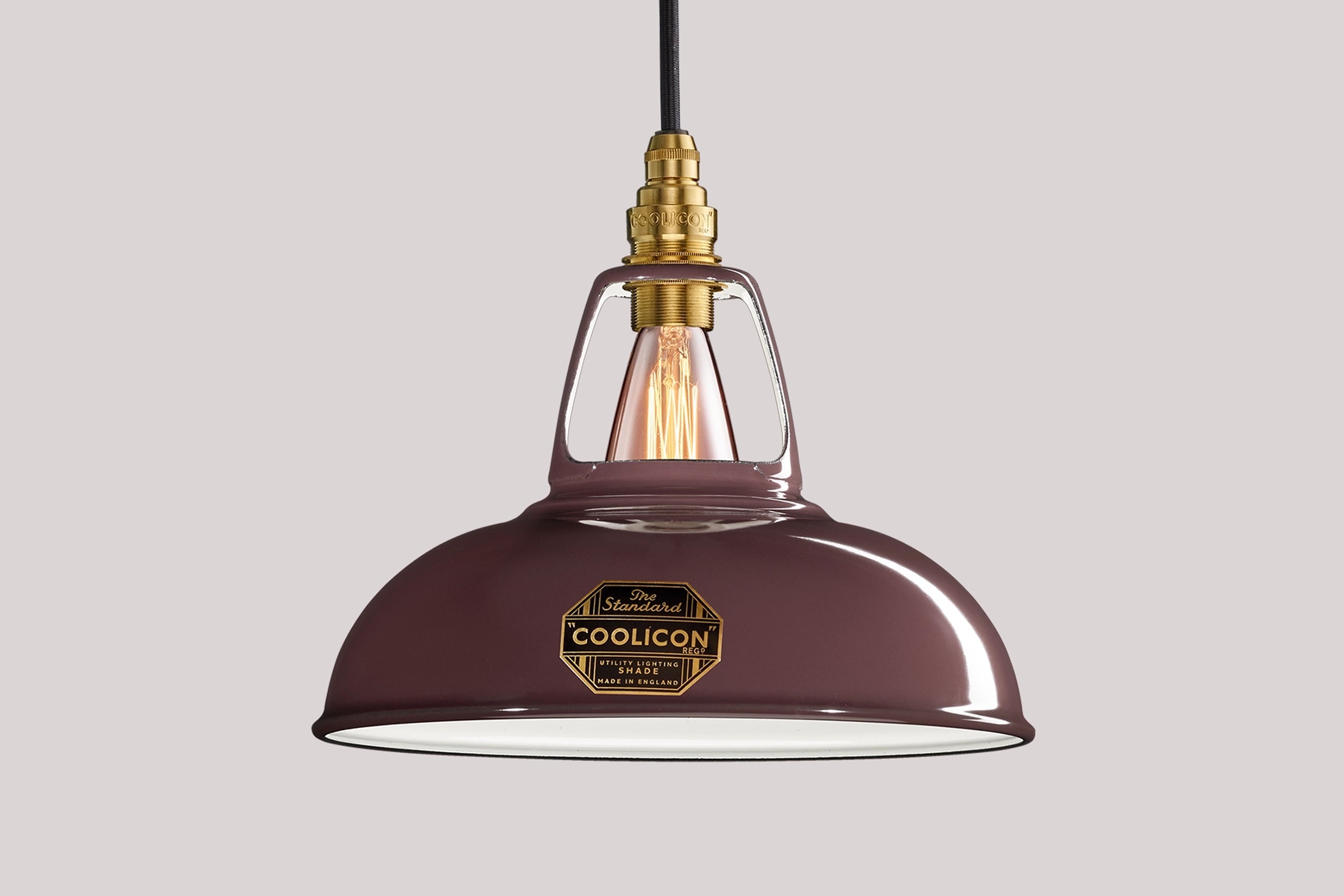 Metropolitan purple Coolicon lampshade with a Signature Brass pendant set over a light purple background